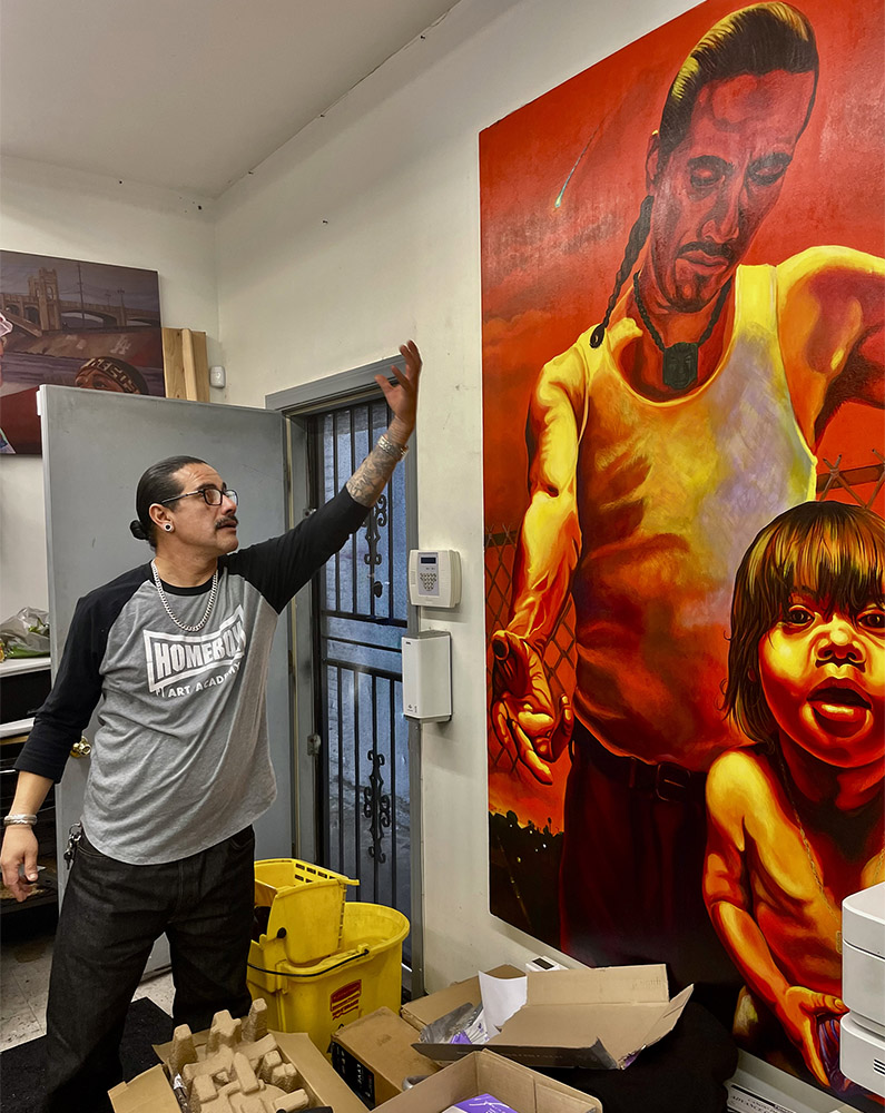 Hector of Homeboy Art Academy shows off painting